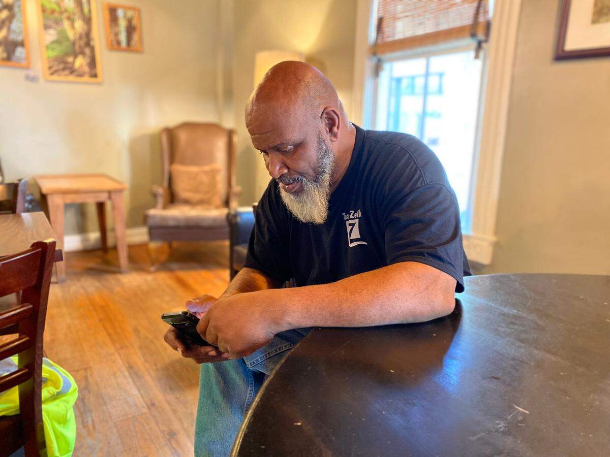 Jordan Jinks, 51, of Yemassee looks at his phone on Friday, December 10, 2021, days after being named as a victim in financial indictments brought against Alex Murdaugh, who is a longtime family friend of Jink’s.