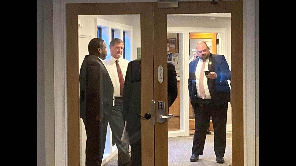 Ward 1 Councilman Alex Brown (left), Mayor Alan Perry (center) and Deputy Town Manager Josh Gruber during the five-minute recess Perry initiated after a dispute with local government critic Skip Hoagland. Hoagland had argued for an additional three minutes to speak at the meeting.