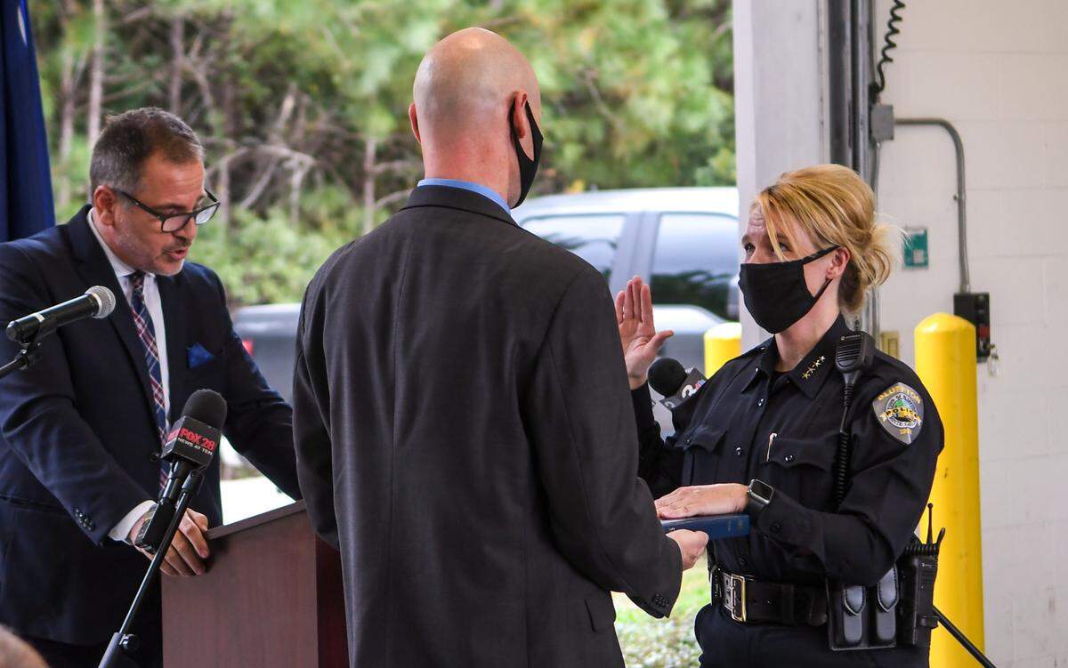 Marc Orlando, left, Bluffton’s town manager reads the oath of office on Monday, Oct. 12, 2020 as Stephenie Price, right, assumes the responsibilities of the town’s chief of police.