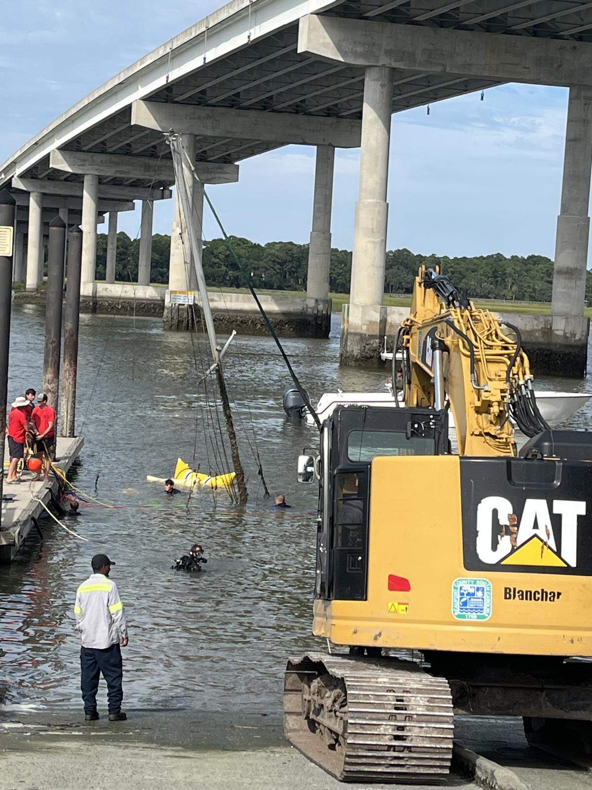 South Carolina Department of Natural Resources divers raise an abandoned sailboat in this handout photo at the Cross Island Boat Landing on Hilton Head Island.