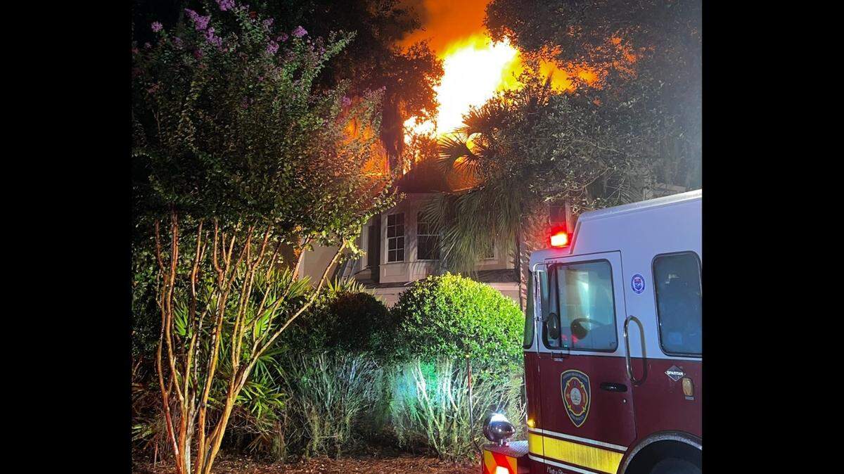 Flames rose above the roof of a Palmetto Dunes rental home during a house fire on Sept. 9, 2022 that killed one tourist and severely injured another. Two lawsuits filed in March and May 2024 allege the short-term rental’s smoke alarms failed to alert guests of the quickly spreading flames.