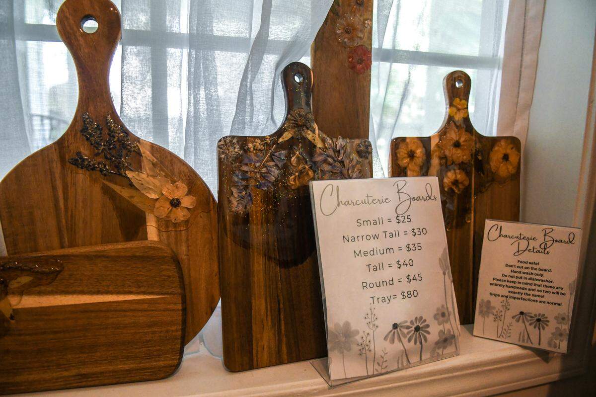 Pressed flowers grown at Helena Hills Farm are decoupaged onto charcuterie boards that are for sale at the farm located in Hardeeville, S.C.