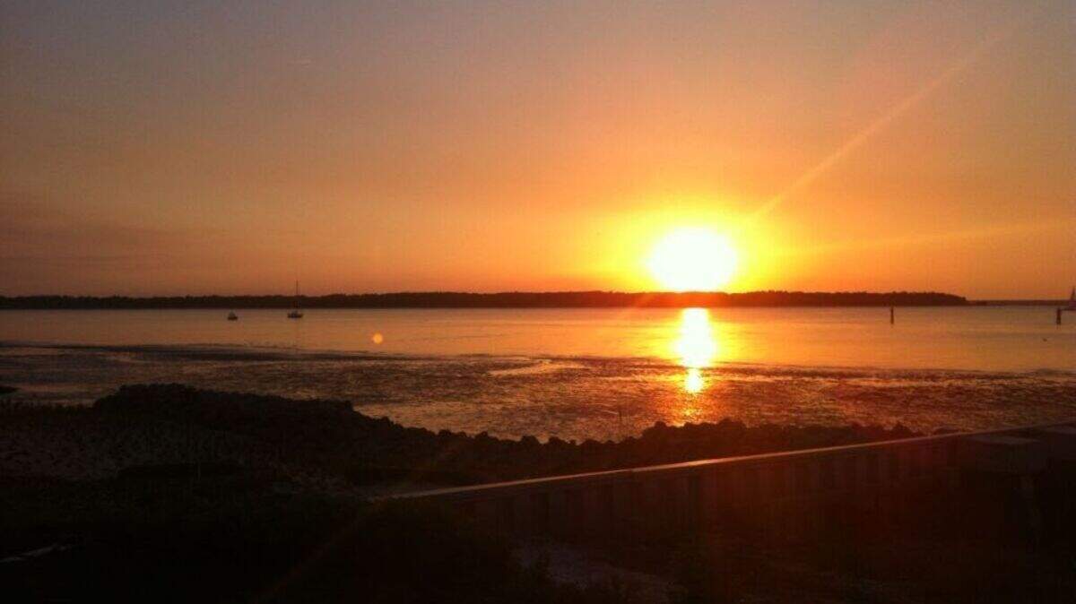 Sunset over Calibogue Sound is best from the grass lawn behind the 18th hole.