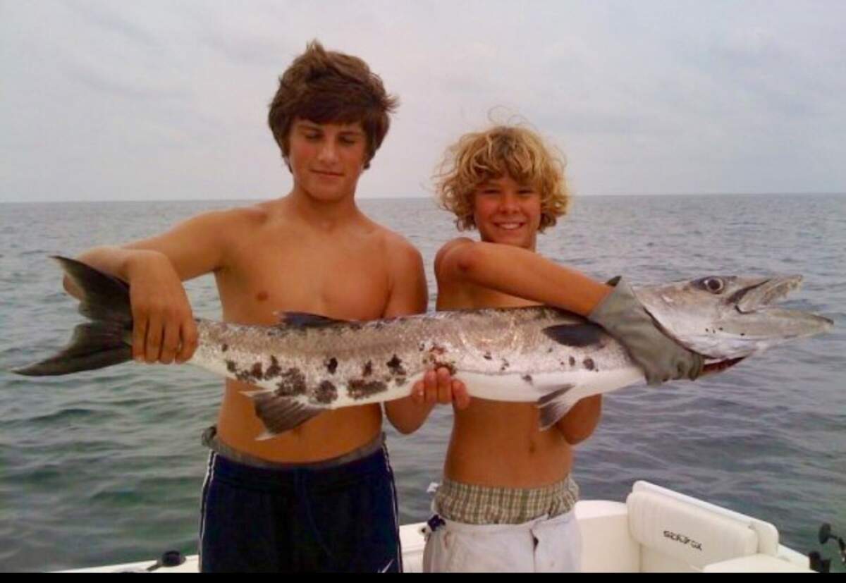 Ryan Hartman, left, with Justice Adelman as teenagers working with Captain Tommy Bronsky on his charter boat Shadow out of South Beach Marina on Hilton Head Island, S.C.