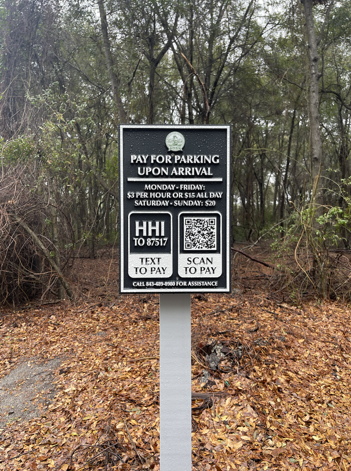 Signs labeled “Pay for parking upon arrival” are scattered throughout Fish Haul Beach’s parking lot on Monday, March 10. Beach goers have the choice of texting “HHI” to the number posted or scan the QR code from their phone’s camera to start the payment process.