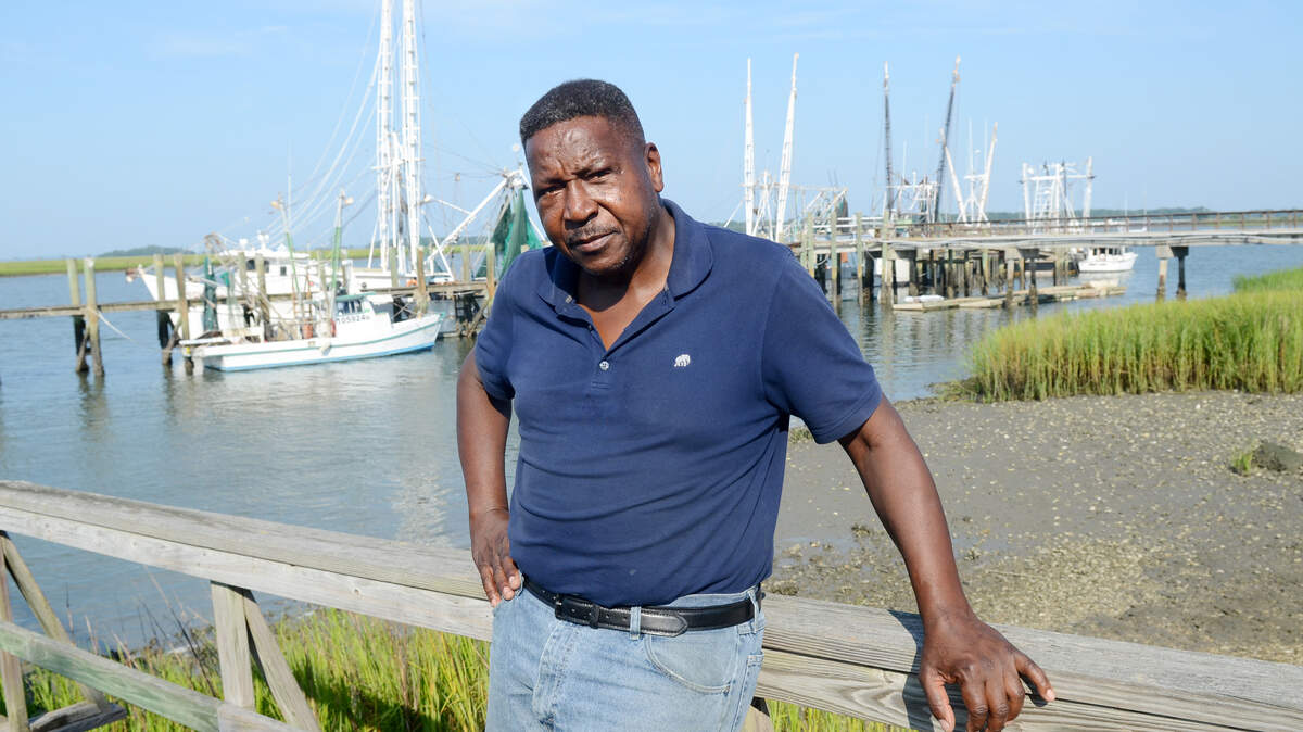 Charles Abner, who keeps his shrimp boat docked at the 11th Street docks in Port Royal, background, was one of the shrimpers affected when the seafood market and shrimp processing facility there burned down July 19, 2015.