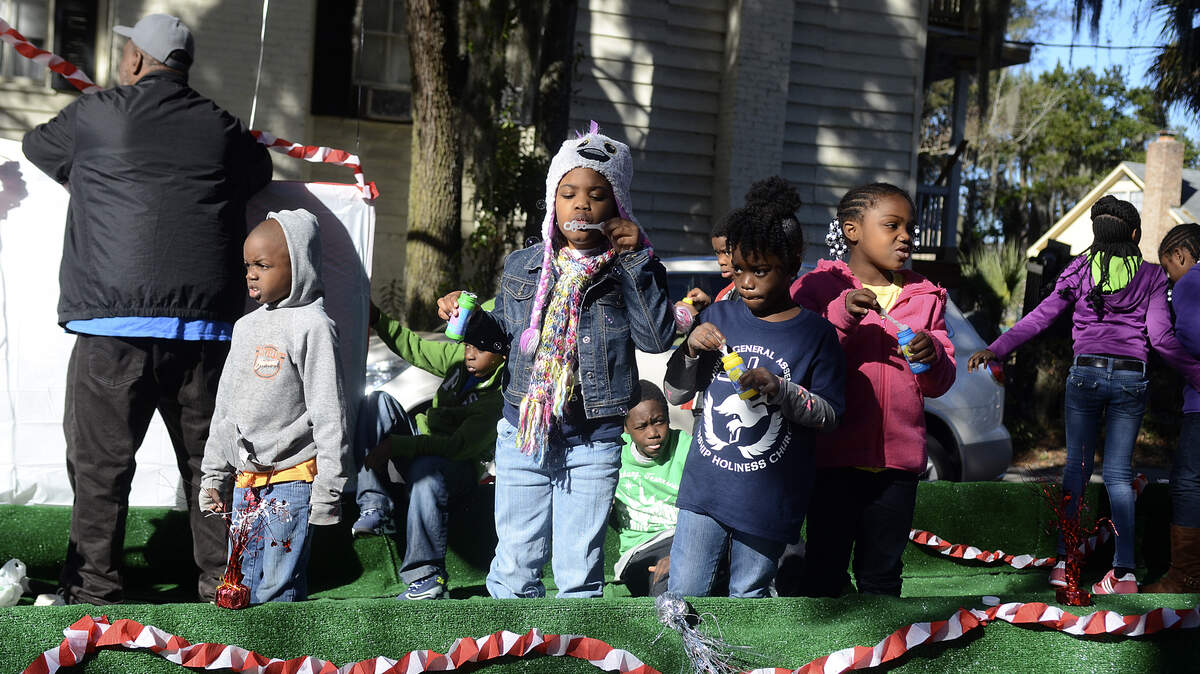 Children blow bubbles from the Friendship Holiness Church float during a 2014 Martin Luther King Jr. Day parade in Beaufort.