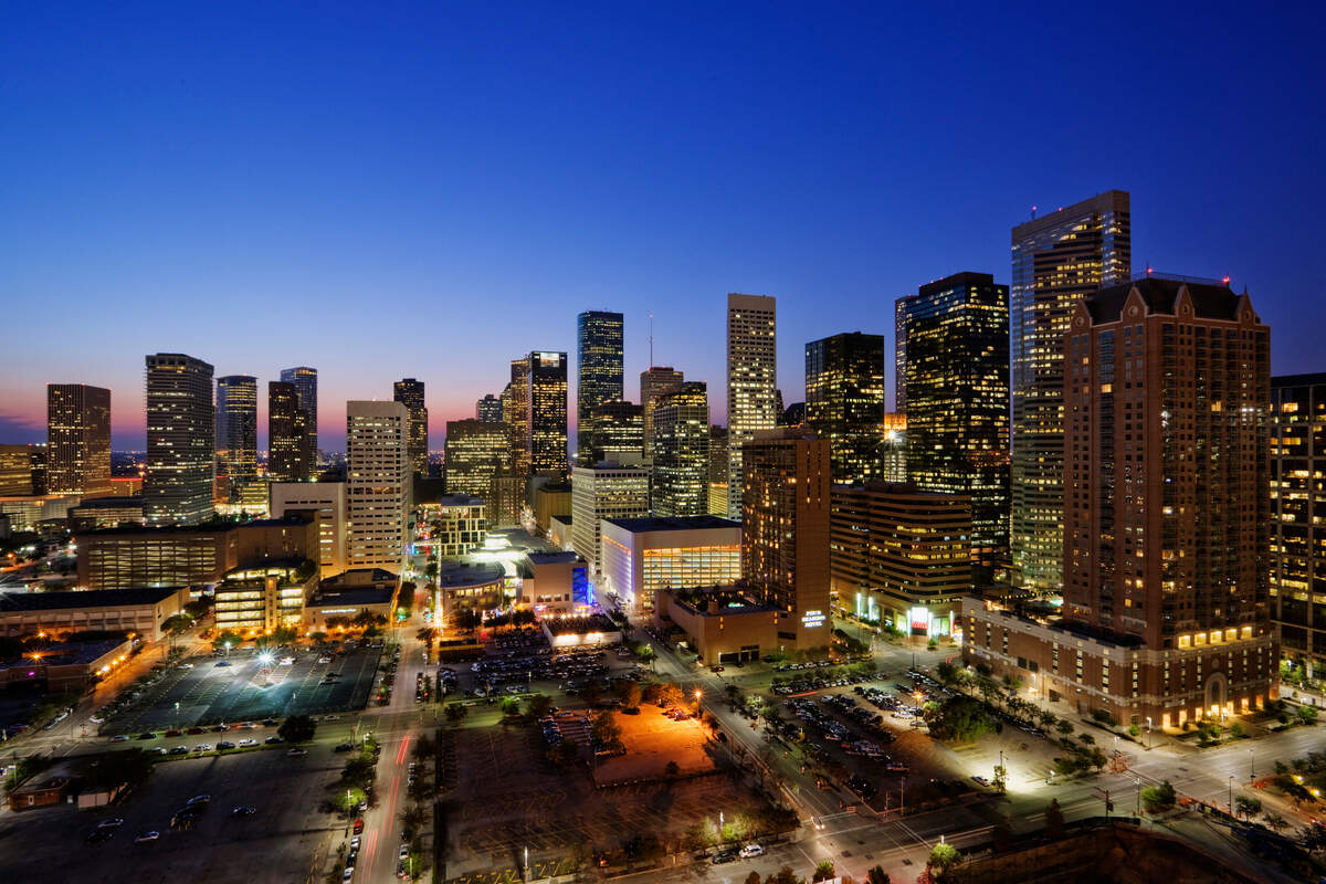 “High rise buildings in Houston cityscape illuminated at sunset, Texas, United States”