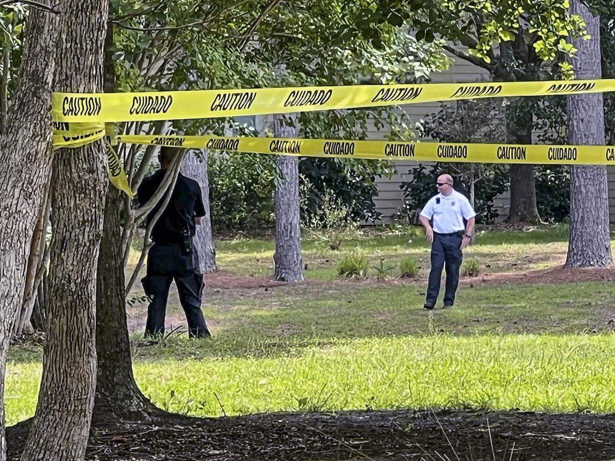 Caution tape surrounds an area near a Commodore Dupont Street lagoon after law enforcement responded to an alligator attack that killed a person on Monday, Aug. 15, 2022 in Sun City Hilton Head.
