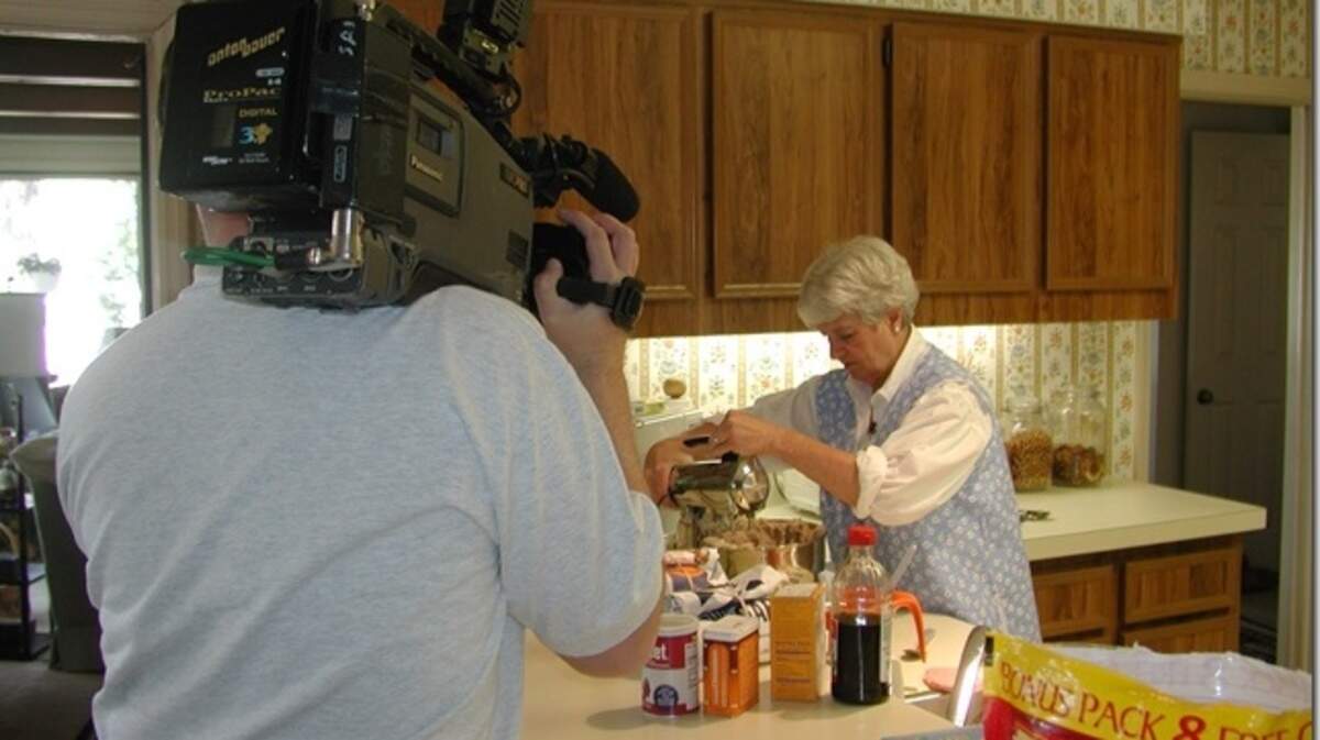Jeanette Cram being filmed for a Savannah television story while baking cookies in her kitchen on Hilton Head Island.