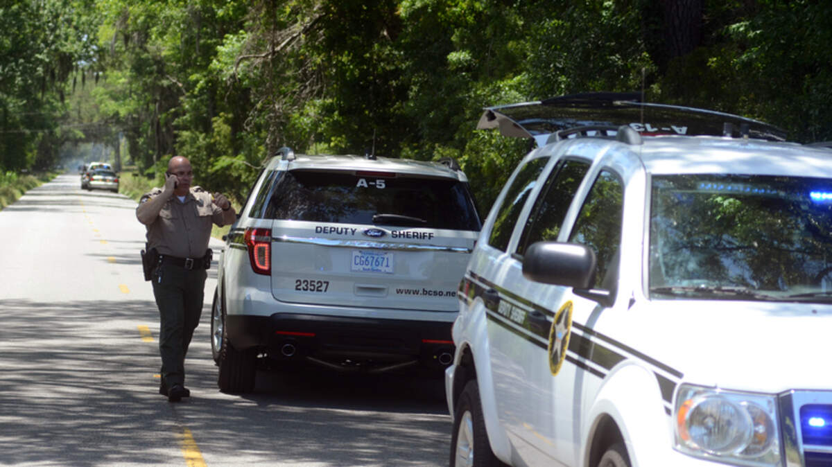 In this file photo from May 11, law enforcement with the Beaufort County Sheriff's Office line up along Seaside Road during a manhunt for a suspect on St. Helena Island.