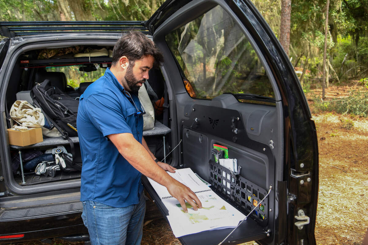 Working out of the back of his SUV, Elvio Tropeano shows the plan for his development of Pine Island Golf Club on May 23, 2023 while parked on the mainland bluff of Pine Island Plantation on St. Helena Island.