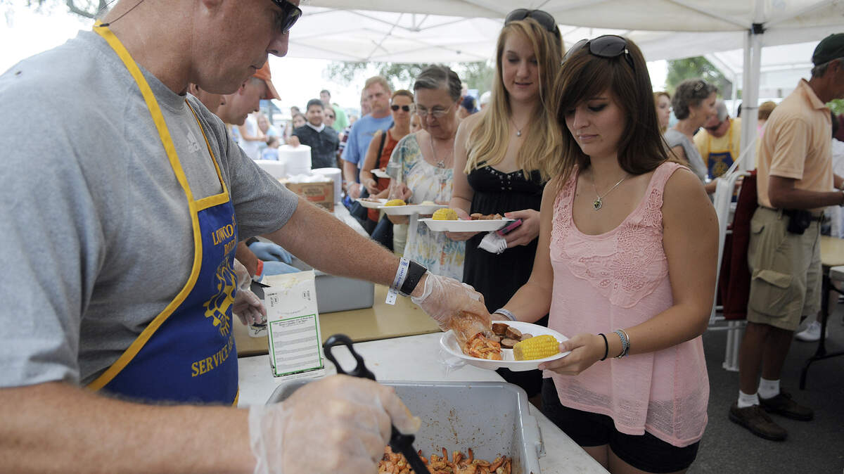 FILE: People wait in line to add shrimp to their Frogmore Stew during the 58th Annual Beaufort Water Festival's Lowcountry Supper at Beaufort's Henry C. Chamber Waterfront Park.