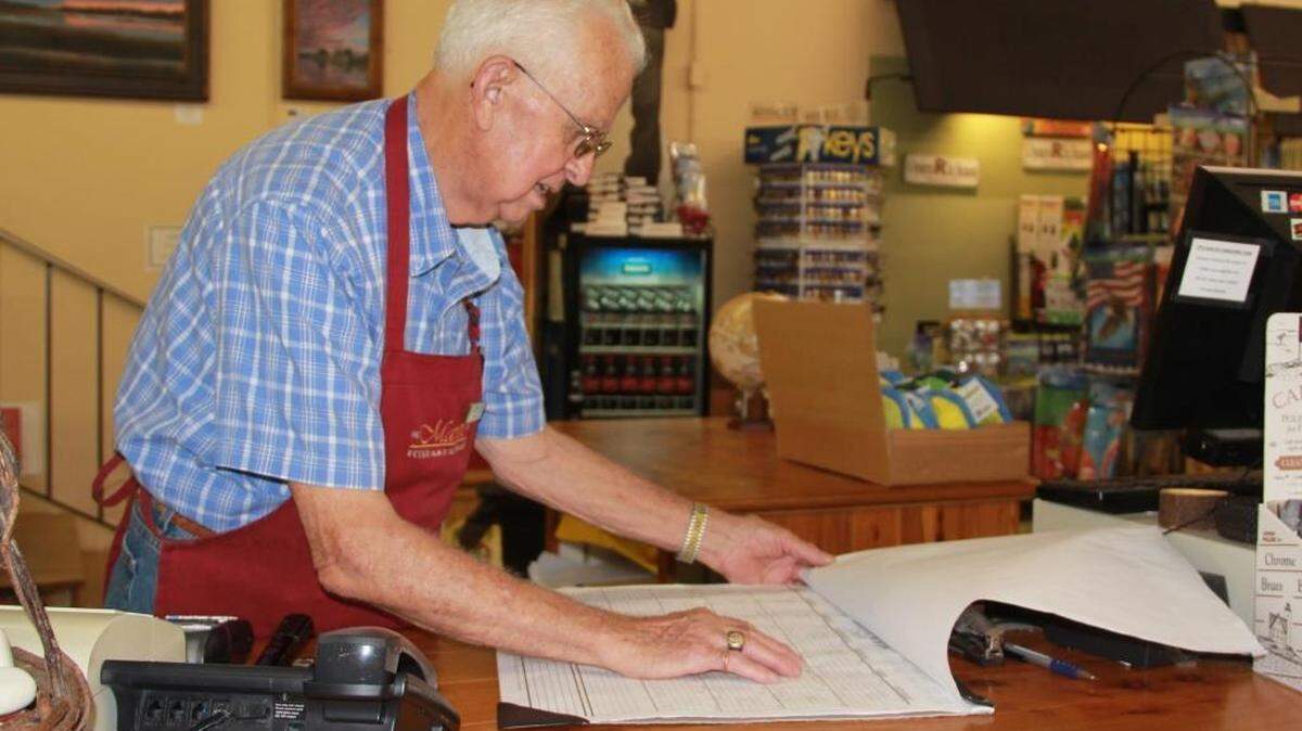 Bob Pinkston checks out the work schedule at Fordham Market.