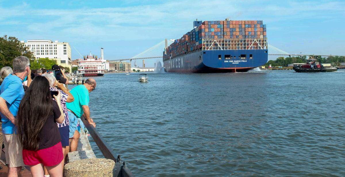 People watch as the massive container ship Marc Polo, the largest ship to set port in Savannah, cruises past Savannah’s Historic Riverfront on Wednesday, May 26, 2021.
