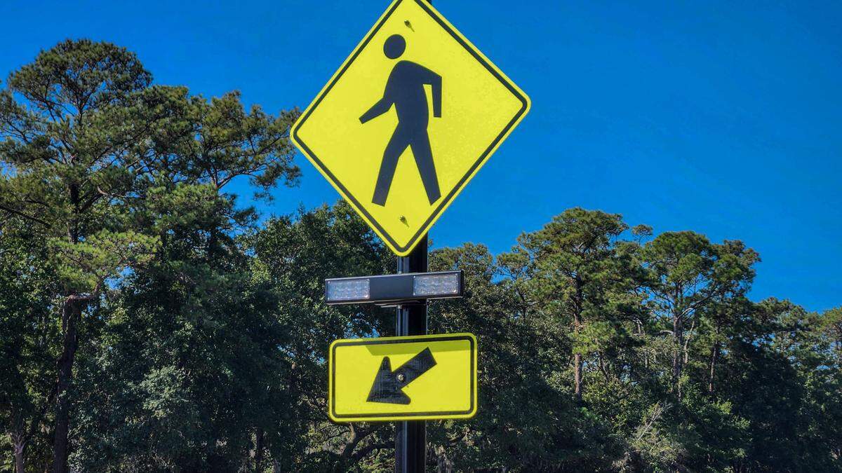 One of several pedestrian crosswalk signs – this one posted at Northridge Drive on William Hilton Parkway – with an attached Rectangular Rapid Flashing Beacon (RRFB). The Town of Hilton Head is attempting to make crossing U.S. 278 more safe by offering pedestrians the ability to activate the beacons making drivers aware that they would like to cross the eight-lane highway.