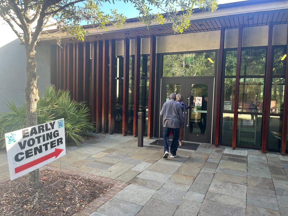 Residents enter the early voting center at the St. Helena Branch Library Friday morning.