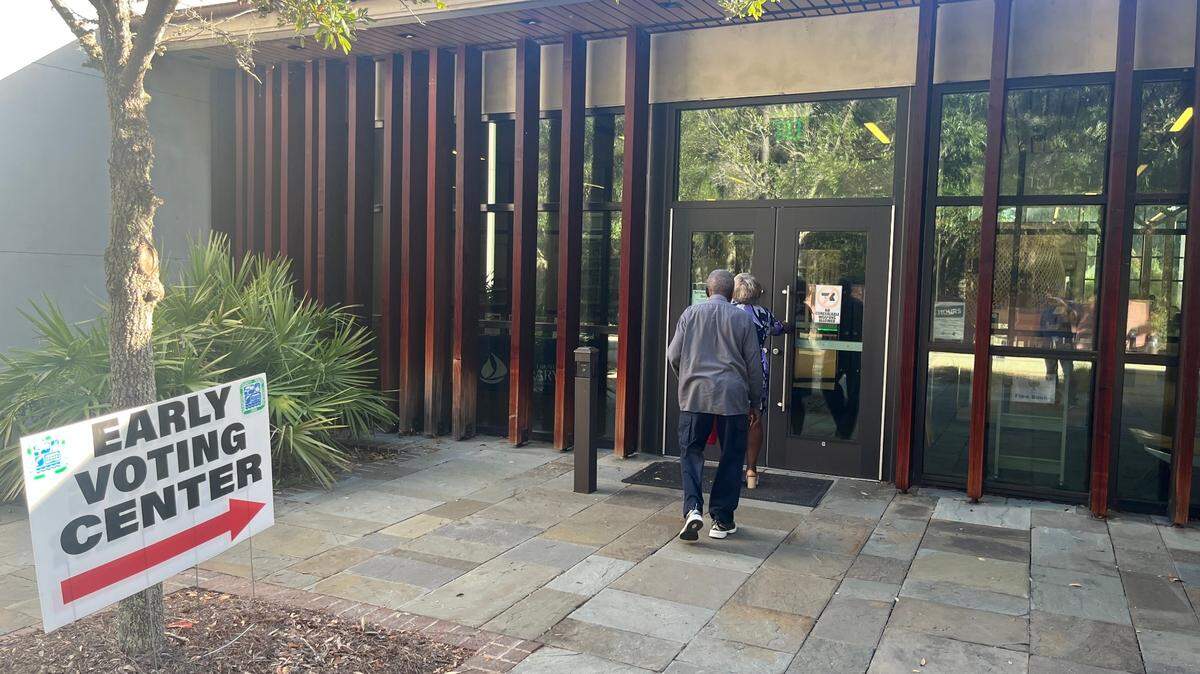 Residents enter the early voting center at the St. Helena Branch Library Friday morning.