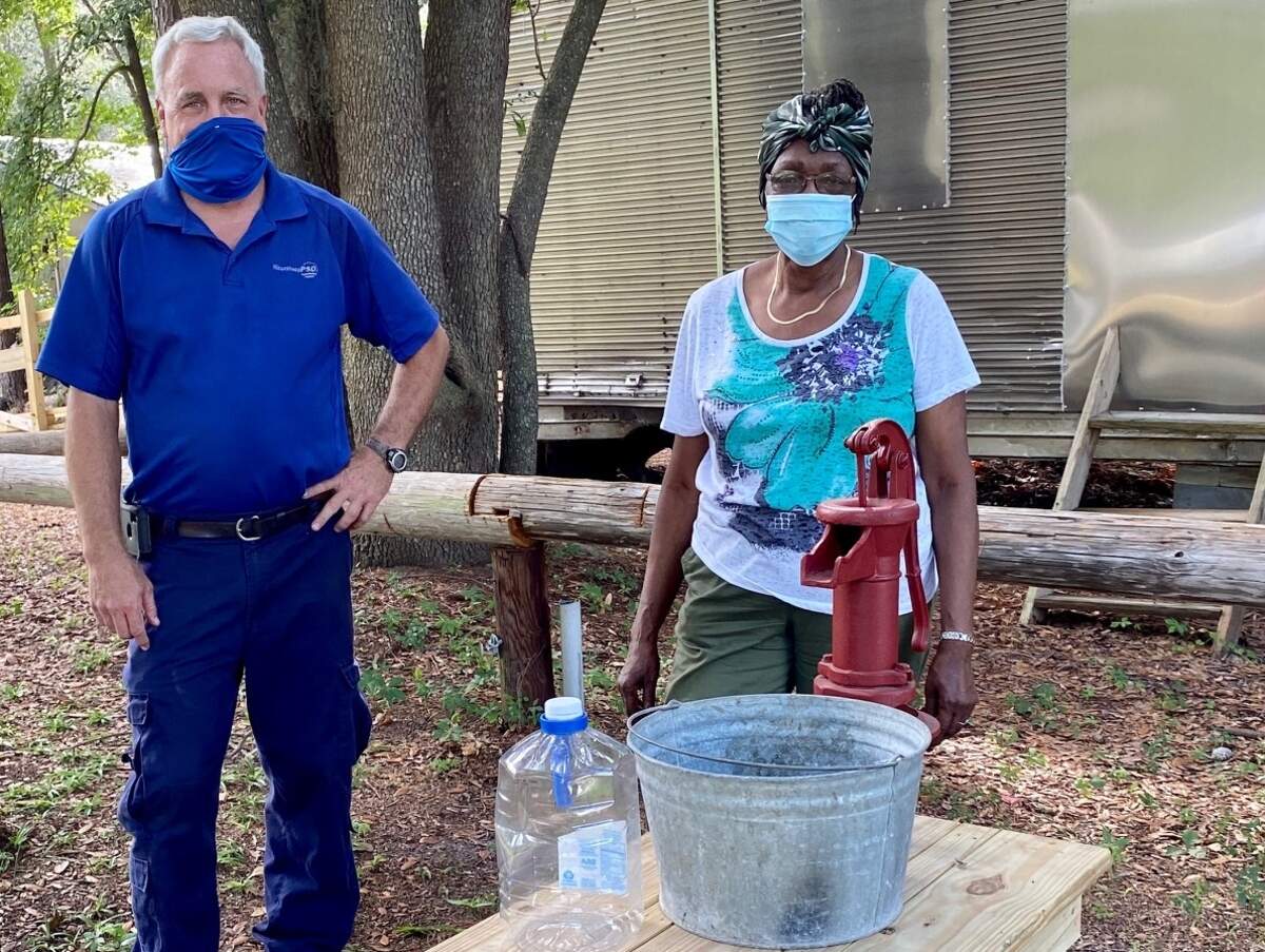 Johnny Malphrus, with Hilton Head PSD, stands with Louise Cohen, of the Gullah Museum, in front of the museum’s new vintage well.