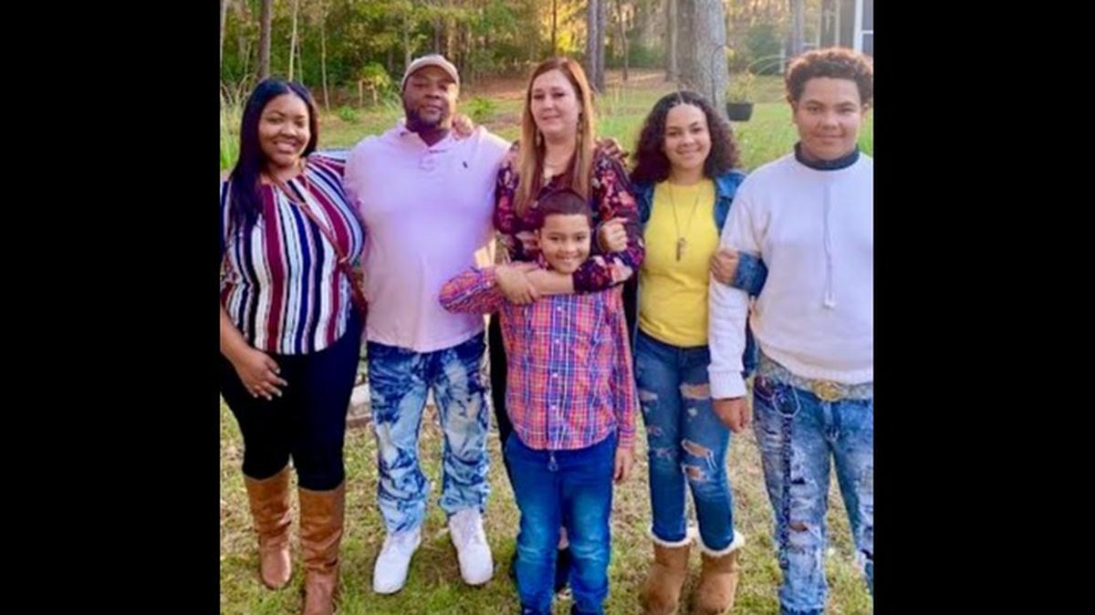 The Busby family with Lexi pictured in yellow and Layton in flannel.