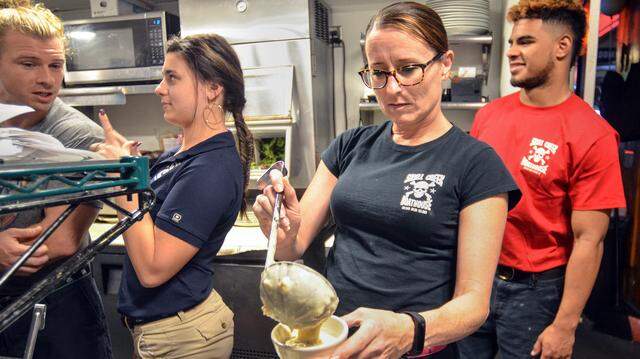 Kelly Homan fills a bowl of soup at Hilton Head Island's Skull Creek Boathouse restaurant on Saturday, April 28, 2018. To make ends meet, Homan, who is a guidance counselor at Bluffton High School, also works at the restaurant on weekends during the school year and during summer break. "It is what I need to do," she says.