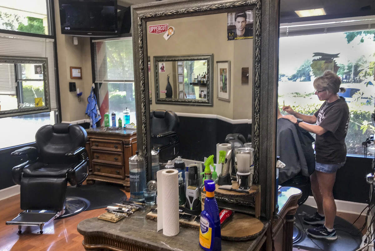 A customer gets a haircut at Barbers of the Lowcountry in Bluffton. One barber, Paddy Myers, says coronavirus is a “daily concern” at the shop, as they worry about their own health and the health of their business.