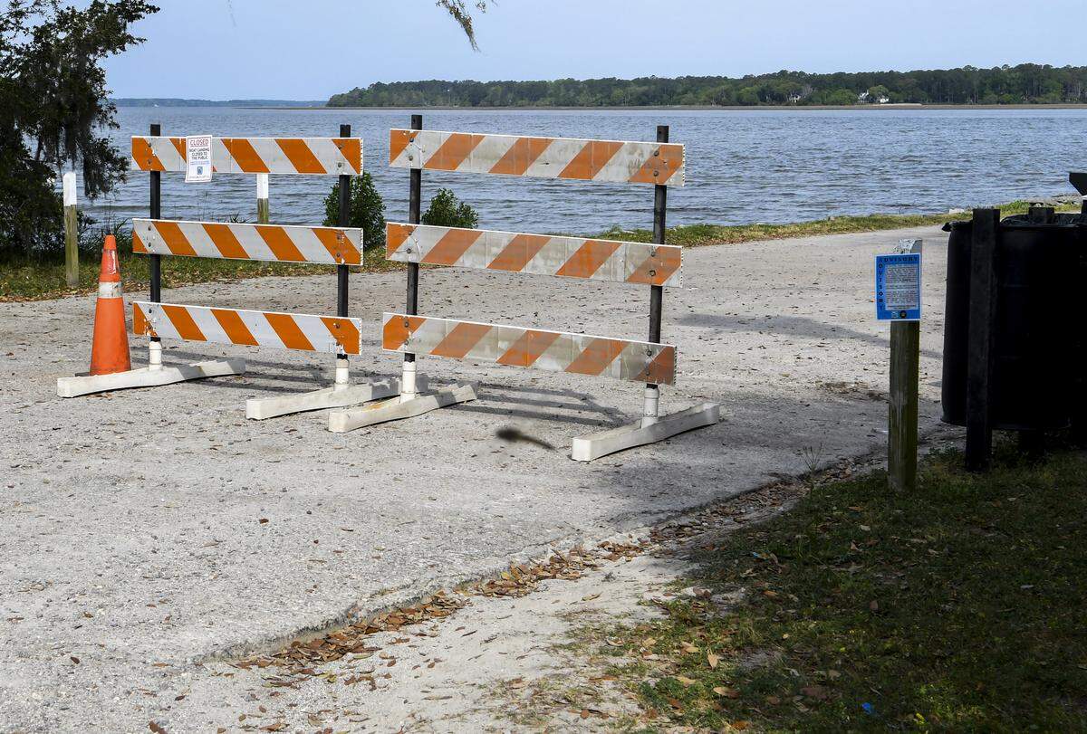 In this file photo of H.E. Trask Boat Landing from April 2020, barricades and a sign warn that the state’s boat landings and beaches are closed in hopes of stemming the spread of the coronavirus.