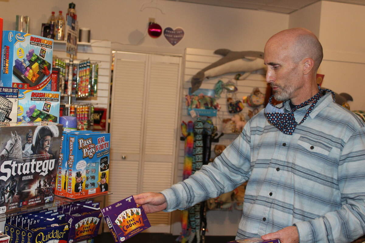 Joe O’Brien arranges merchandise in his store, Monkey’s Uncle in Beaufort.