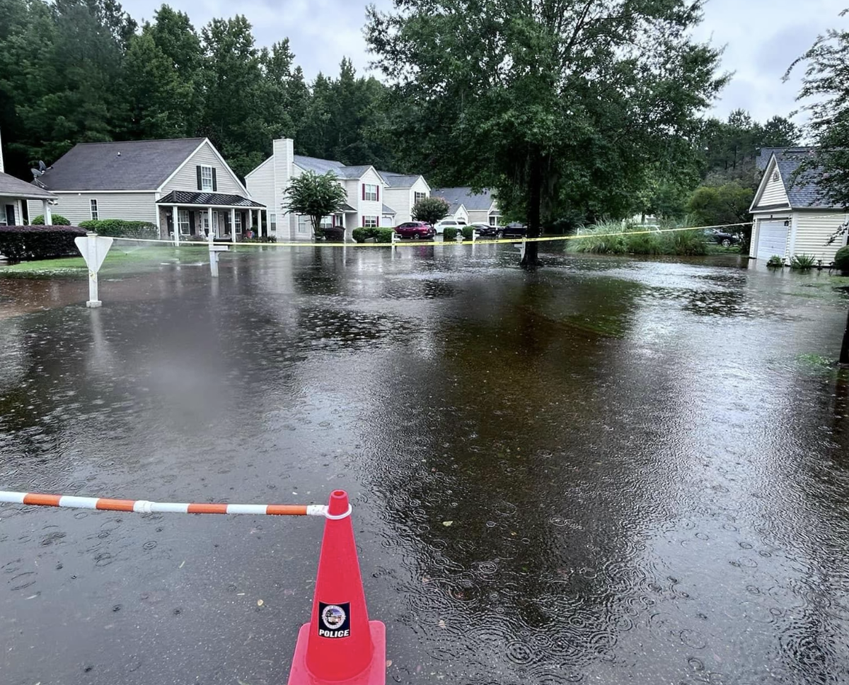A photo taken Wednesday afternoon in The Farm at Buckwalter shows blockades discouraging travel through a portion of flooded roadway. Bluffton police had closed one of the neighborhood’s two entrances as rainfall from Tropical Storm Debby continued to inundate the low-lying area.