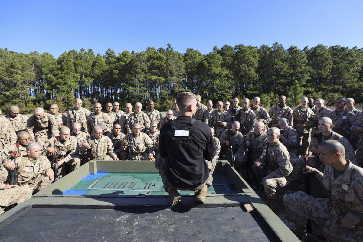 Sgt. Jacob Freeman with Field Training Company, Weapons and Field Training Battalion, briefs recruits on event six of the Crucible aboard Marine Corps Recruit Depot Parris Island, S.C., Jan. 14, 2021. Recruits are briefed on the terrain and mission before starting the event.
