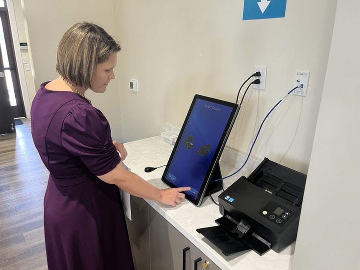 Library Director Amanda Brewer Dickman uses the self-service scan-fax-email station at the Samuel E. Murray Library in Port Royal Wednesday, when the branch openened.