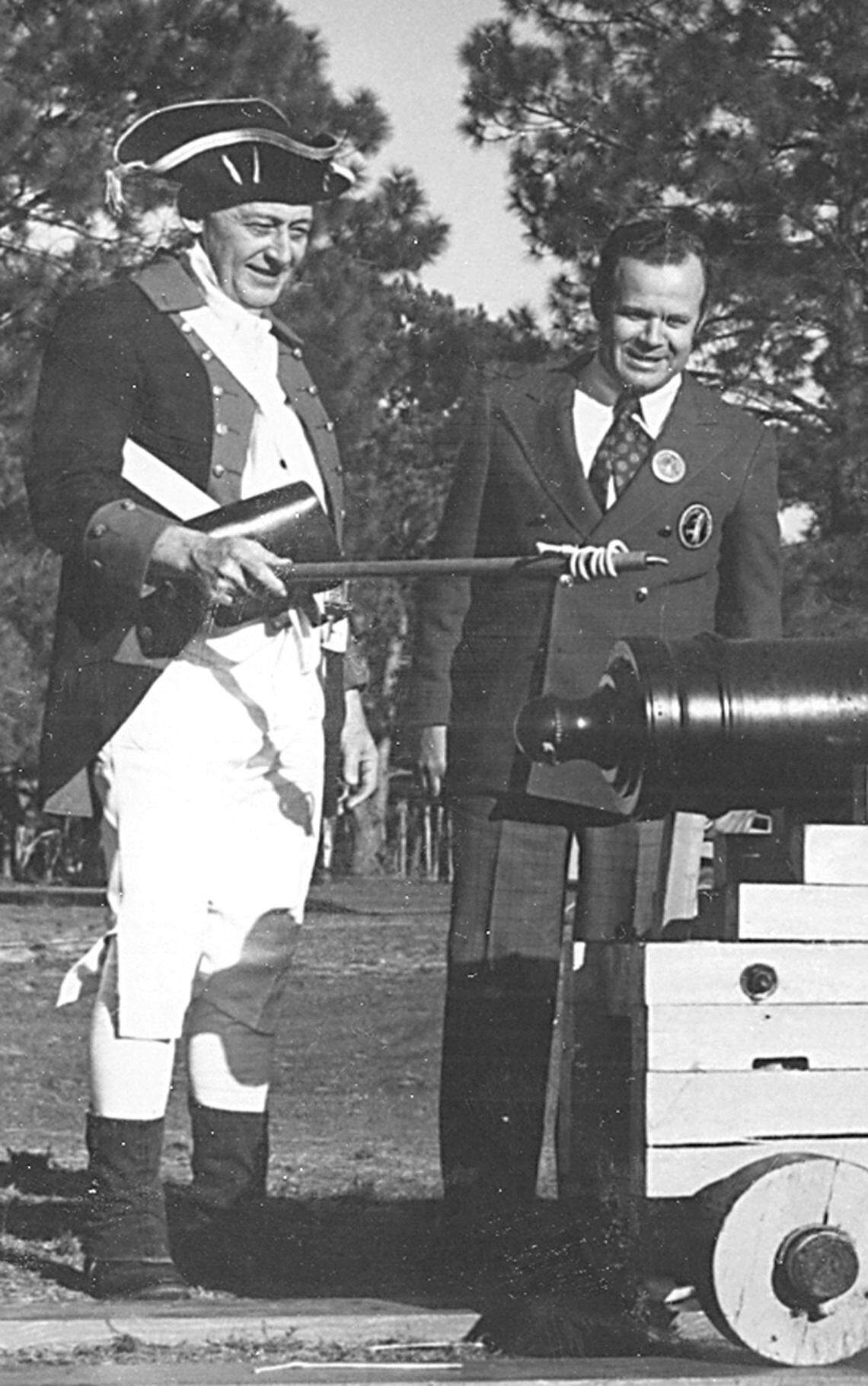 In this provided, undated photo, Charles Fraser, right, is seen with a cannoneer with the cannon that's been used to start the tournament since its inception.