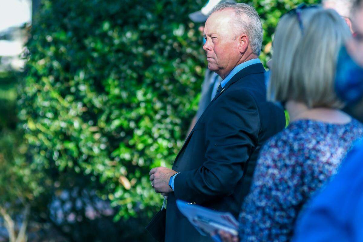 Beaufort County Sheriff P.J. Tanner, socially distanced, holds his face covering while listening to speakers at Beaufort Police Chief Matt Clancy’s public funeral on Aug. 7, 2020 at Henry C. Chambers Waterfront Park in Beaufort.