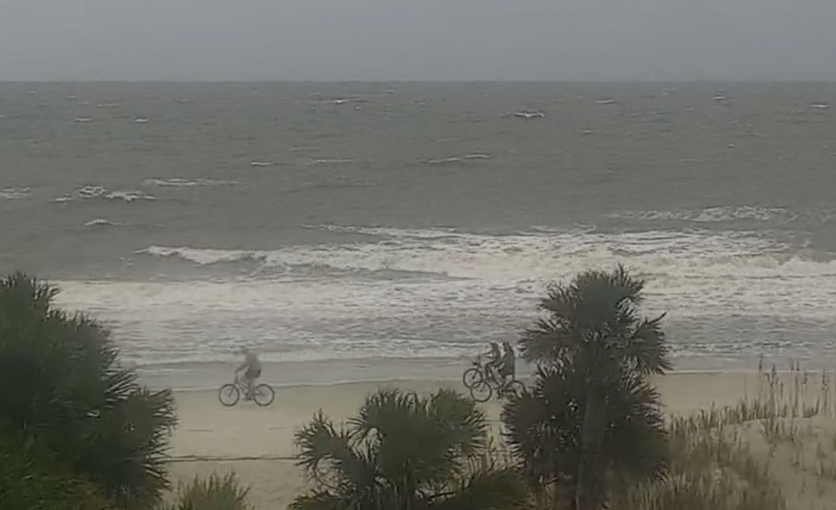 A group of bicyclists were seen on Singleton Beach around noon Thursday as Hurricane Helene brought gray skies and choppy surf to Hilton Head Island. Town officials are urging islanders to stay home if possible.