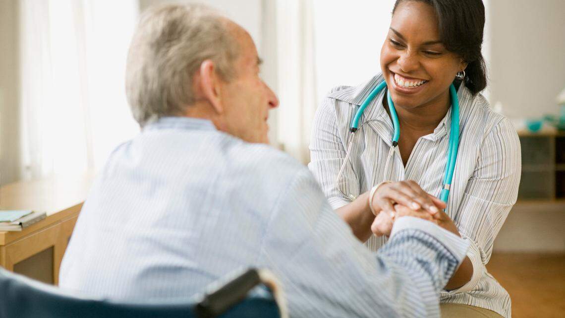 Nurse and elderly man spending time together