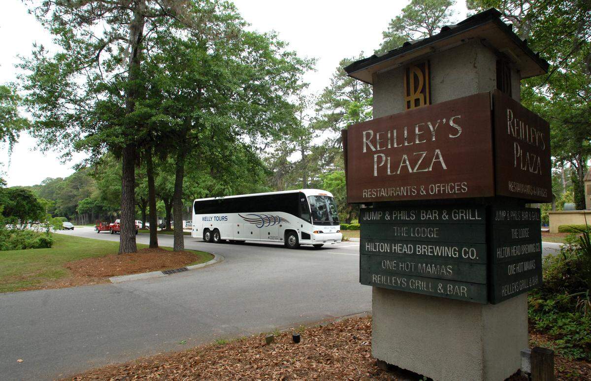 A shuttle bus rolls past Reilley’s Plaza -- known to locals as the “Barmuda Triangle” -- just past the Sea Pines gate as it carries tournament goers out of the RBC Heritage Presented by Boeing golf tournament on Friday. The new tournament parking out at Honey Horn has made traffic a lot lighter on the south end of Hilton Head, but merchants have noticed a similar fall-off in business compared to past years.