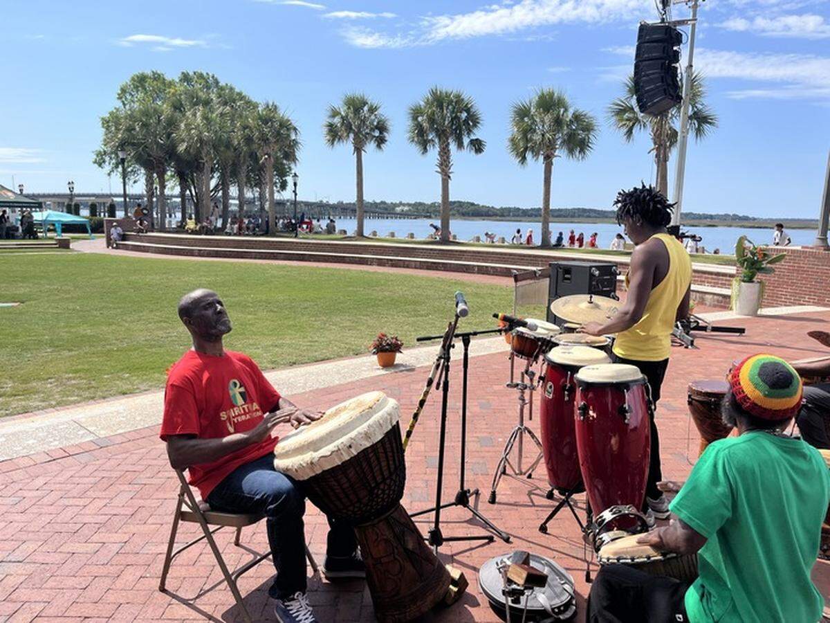 Vincent Dratin, left, Sedeek Prather and Onayemi Olalekan (Kevin Young) with the Spiritual Vibrations perform during the opening “drum call” at the Original Gullah Festival Friday. Not pictured is Willie Bleach.