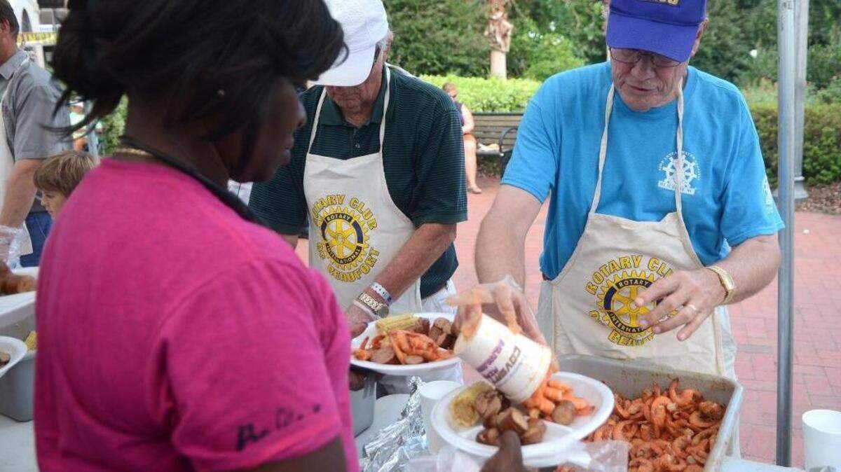 Nick Hunt, of Beaufort, with the Rotary Club of Beaufort, serves Rose Marie Speaks shrimp at the Lowcountry Supper during the 62nd Annual Beaufort Water Festival at Henry C. Chambers Waterfront Park in 2017. The Lowcountry Supper returns Thursday.