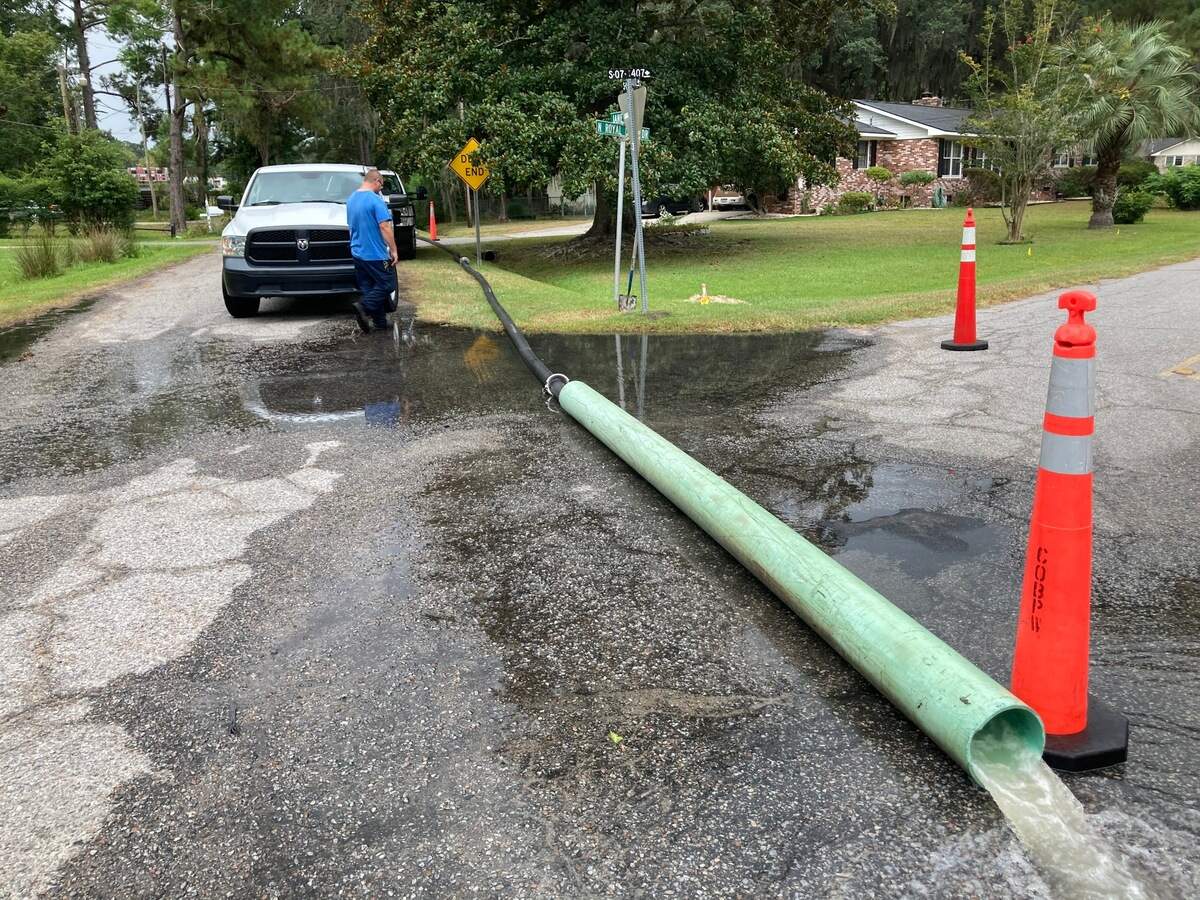 City of Beaufort public works employees pump water from a large ditch on Jane Way in the Mossy Oaks area ahead of Tropical Storm Isaias on Monday morning.