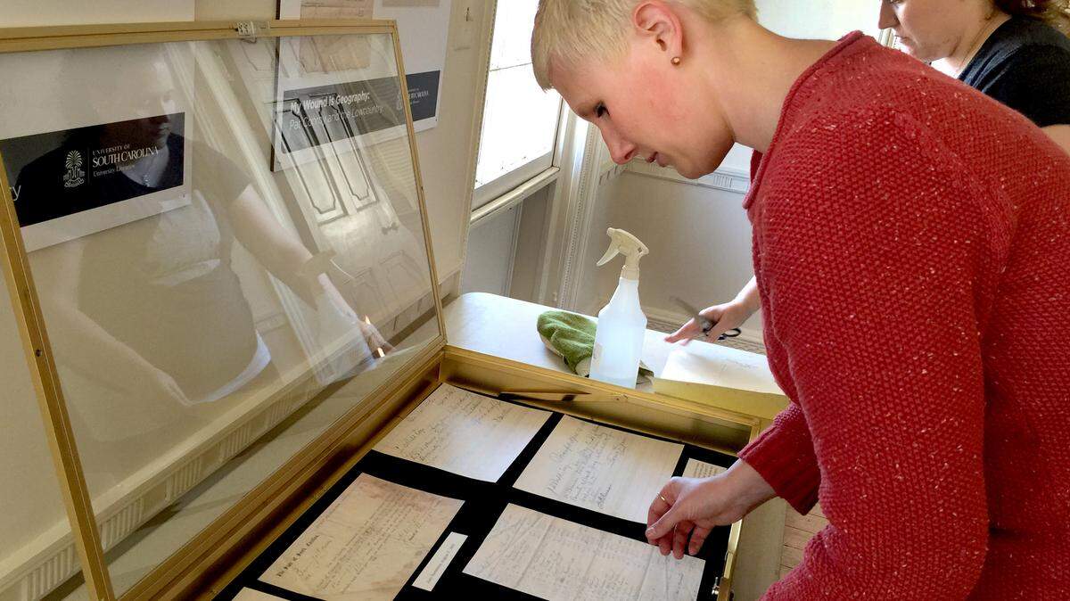 Jessica Dowd Crouch, archivist at Irvin Department of Rare Books and Special Collections at the University of South Carolina's Ernest F. Hollings Library and curator of the "My Wound Is Geography: Pat Conroy and the Lowcountry" exhibit at Historic Beaufort Foundation's Verdier House, which opens Oct. 24, arranges material in a display case Monday.
