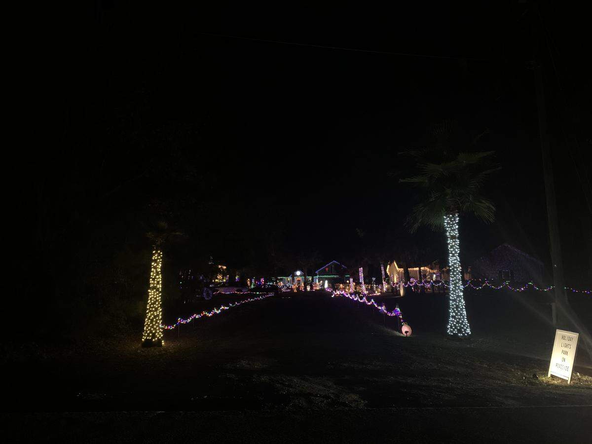 The entrance to candy cane and lollipop lane that leads to a three-house collaborative Christmas light display on Springfield Road.