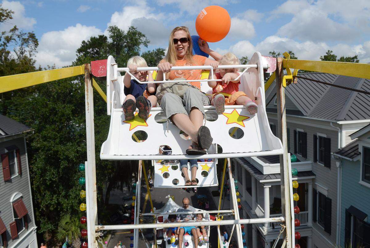 Beaufort's Jennifer Mader, with children Stephen, 5, and Zoey, 3, rides the 47-foot Ferris Wheel at the 7th Annual Habersham Harvest Festival on Saturday.