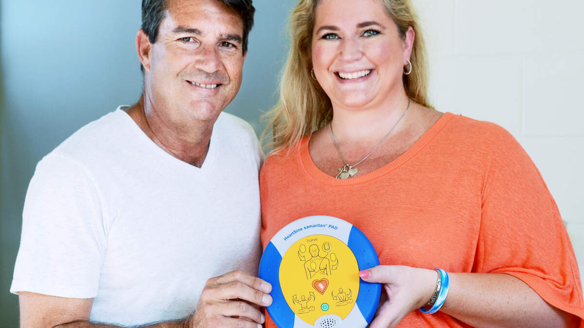 Jim and Amanda Quance pose on Tuesday with a demonstration model of automatic external defibrillator they, in league with local nonprofit Arrhythmia Alliance, hope to have installed in every police car in Bluffton. Their fundraising effort is called the Gavin Quance Campaign, in honor of their 8-year-old son, Gavin, who died last year when police officers who arrived on the scene first could not revive him after he drowned in a pool.