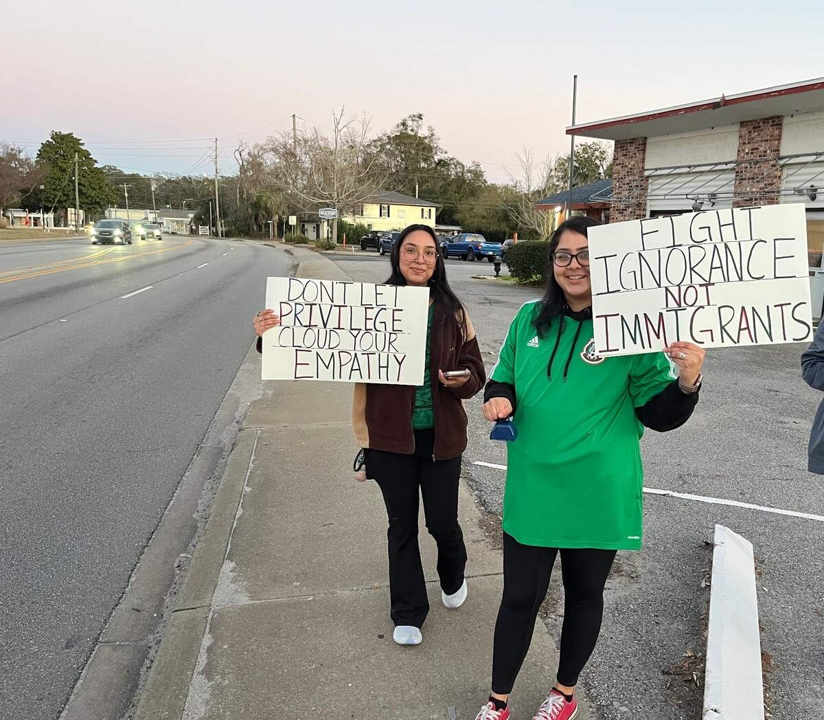 From left, Biara Ortega and Ahtziry Medina of Beaufort hold signs speaking out against the Trump administration’s policy of deporting people living in the country illegally. Medina, who graduated from Battery Creek High School, said she was “fighting for my parents.”