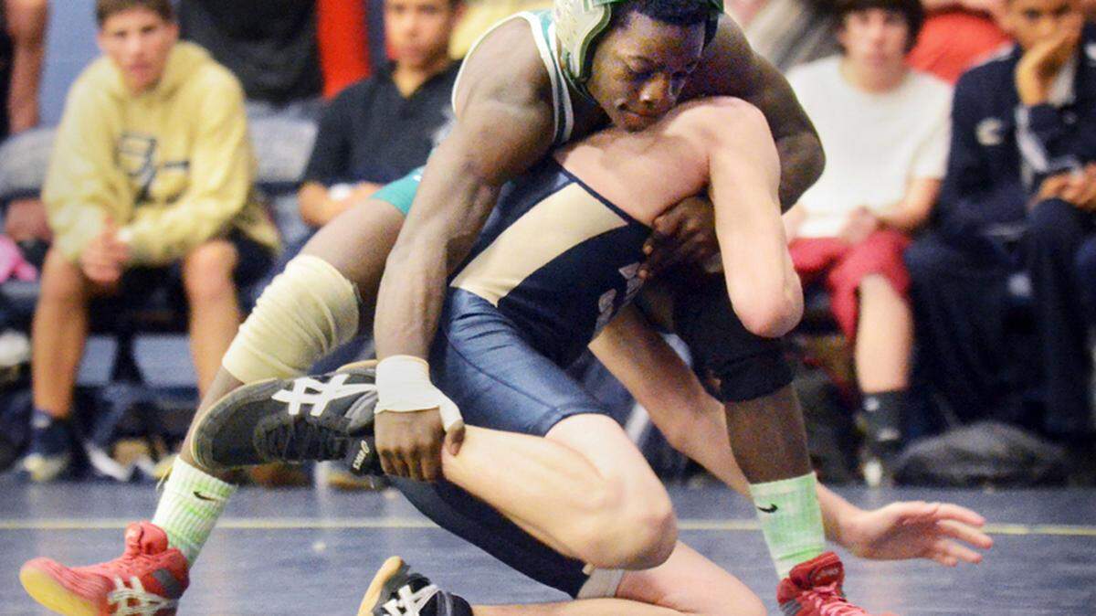 Beaufort's William Spann, top, beat Battery Creek's Jimmy Kearse in their 113-pound bout during the semifinal round of the Coach Trap Memorial Wrestling Tournament at Battery Creek High School on Saturday.