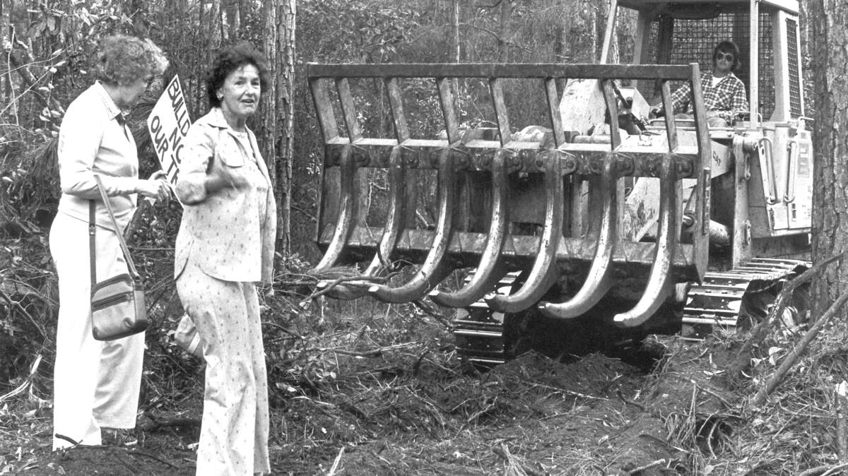 In this March 1985 file photo, Katie Callahan, left, and Jane Plante stand in front of a land clearing machine on Hilton Head Island during a Save Our Trees protest. The group was protesting the clearing of land along Palmetto Bay Road for water line installation.