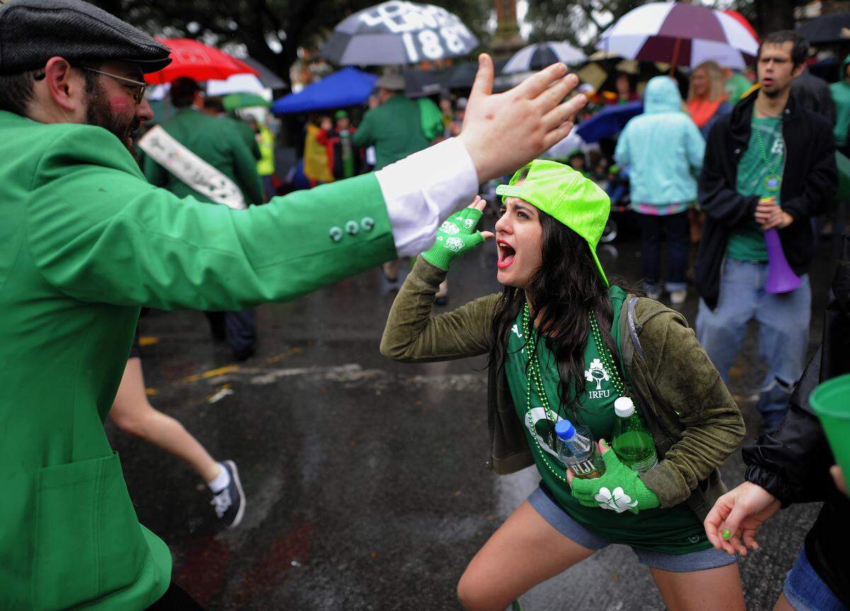 Andrea Sicignano of Long Island, N.Y., high-fives a participant marching in the 2014 Savannah St. Patrick’s Day parade.