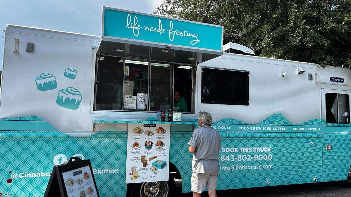 A customer buying a cinnabon one Eagle’s Field Wednesday, one of the truck’s last stops in the area