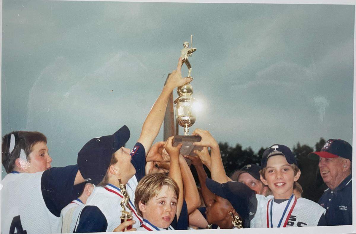 Kids hoist trophy after winning Dixie Youth World Series