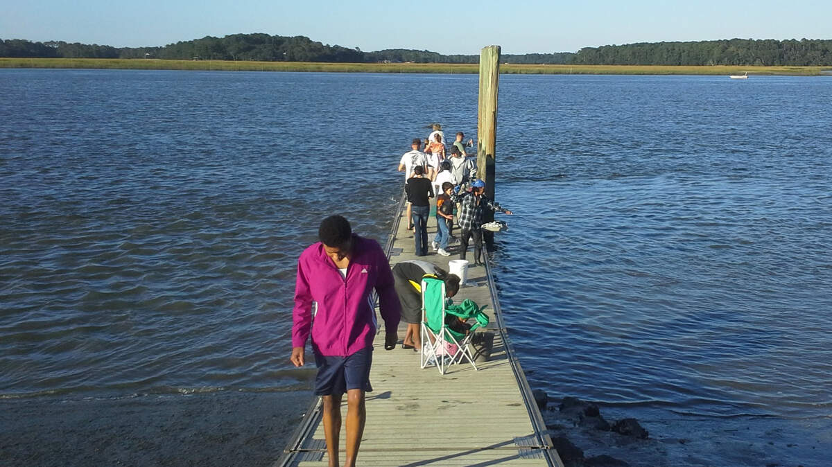 Shrimpers crowd the floating dock at Pigeon Point Landing on Saturday. The dock has reopened following repairs after a fisherman reported structural issues in August.
